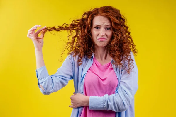upset redhaired ginger foxy woman with dryness tangled red hair