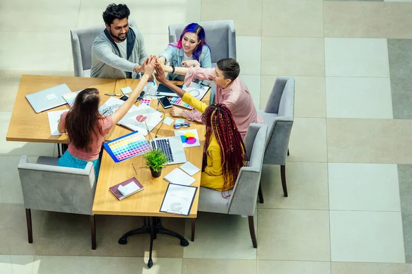 Mixed-race journalist fashion designers working together in a bright office — Stock Photo, Image