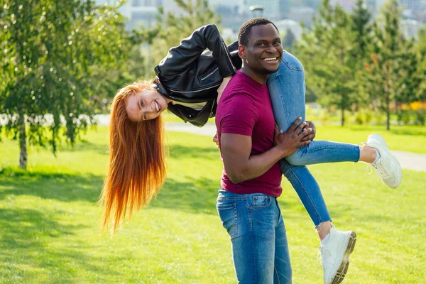 晴れた日に春の夏の公園に一緒に立って彼のガールフレンドを抱きしめる若い男の肖像画 — ストック写真