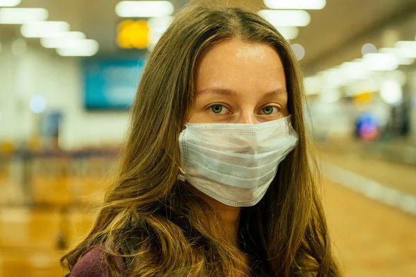 travel woman in mask in airport Flight delay flight cancellation airspace is closed because corona virus epidemic