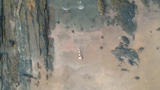 Aerial drone view of young woman on beach top above — Stock Video