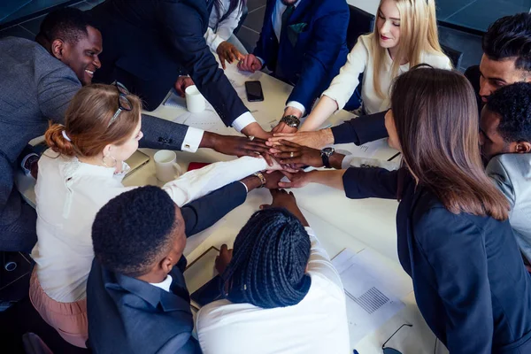 Group of business people rejoicing in closing the quarter successfully tossing up paper documents in the modern office panoramic window — Stock Photo, Image