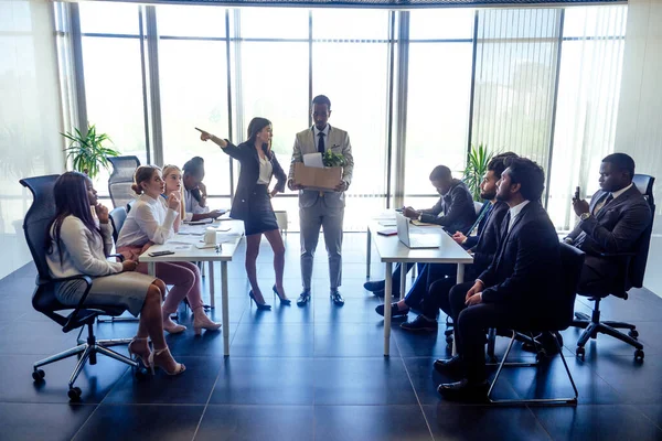 Dissatisfied senior korean boss scolding employees for bad work at diverse group meeting, result at office briefing modern panoramic window.afro man holding box with things and a potted plant — Stock Photo, Image