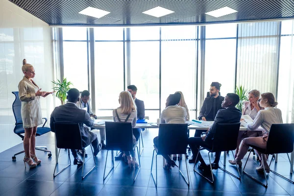 Um grupo de afro-americanos de sucesso, europeus, empresários árabes e coreanos e empresárias trabalhando no escritório com grandes janelas de vidro — Fotografia de Stock