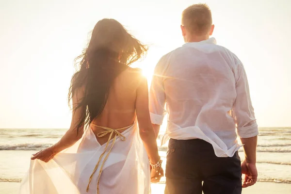 Casal de férias andando na praia juntos no amor ao pôr do sol goa — Fotografia de Stock