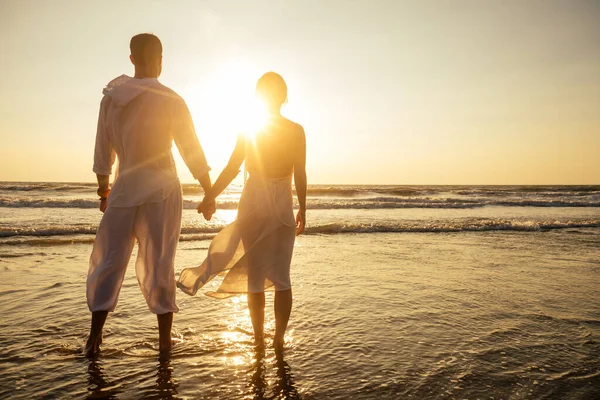 Pareja de vacaciones caminando en la playa juntos en el amor al atardecer goa — Foto de Stock