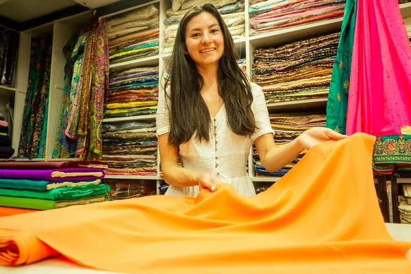 business lady shop owner cashmere yak wool shawls.female seller in goa india