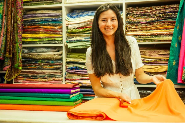 business lady shop owner cashmere yak wool shawls.female seller in goa india