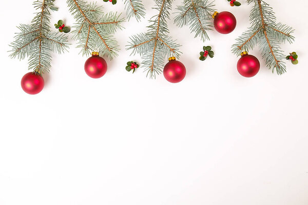 Christmas composition. Christmas gift,pine branch, red balls and red berries. Top view, flat lay, copy space.