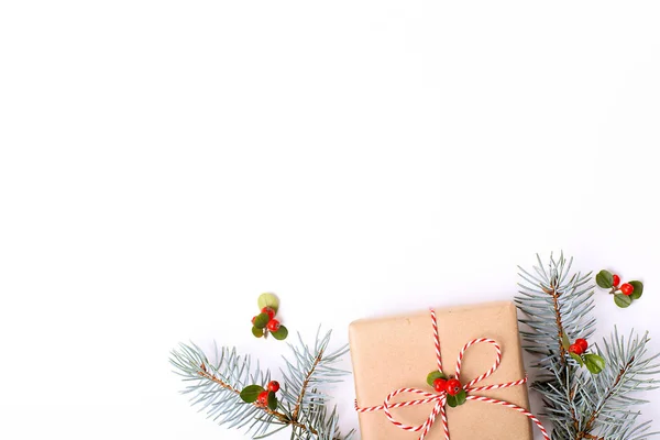 Composizione natalizia. Regalo di Natale, ramo di pino e bacche rosse. Vista dall'alto, disposizione piatta, spazio di copia . — Foto Stock