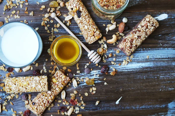 Healthy granola bars on the wooden table.Variety of cereal bars with nuts, seeds, dried fruits and chocolate on the wooden table,top view.