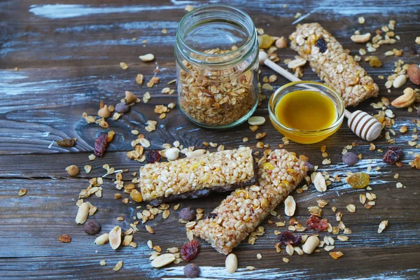 Healthy granola bars on the wooden table.Variety of cereal bars with nuts, seeds, dried fruits and chocolate on the wooden table,top view.