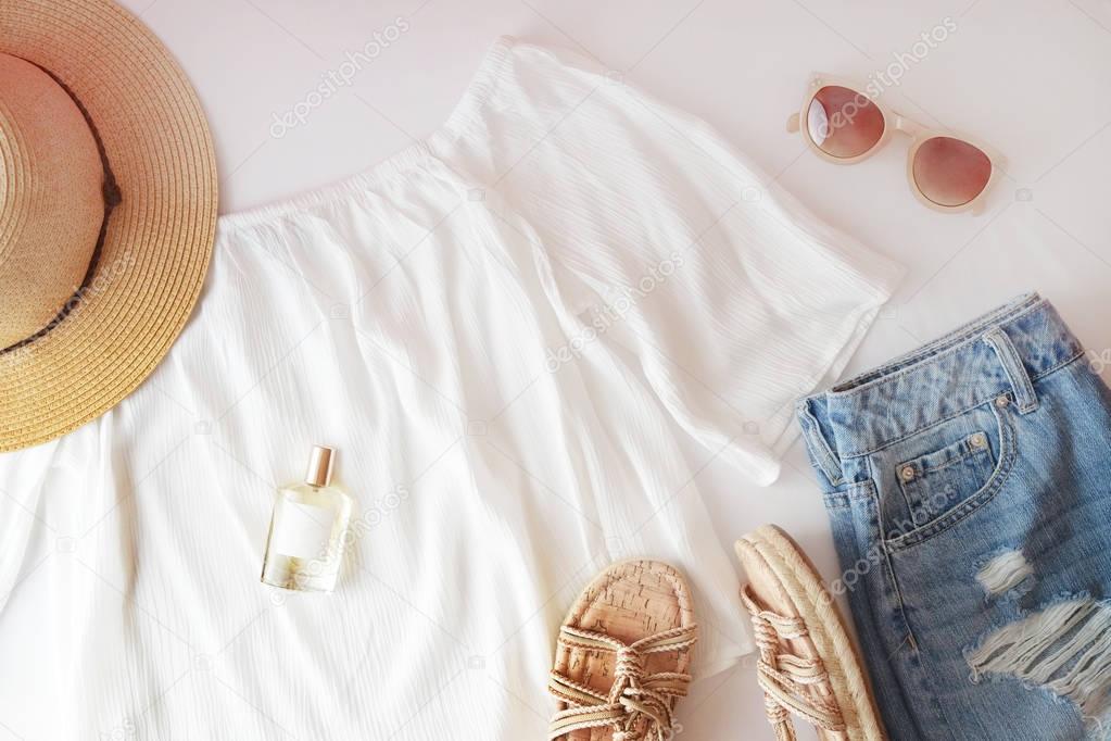 Female summer outfit on white background. Summer trend.  Flat lay trendy fashion feminine background.