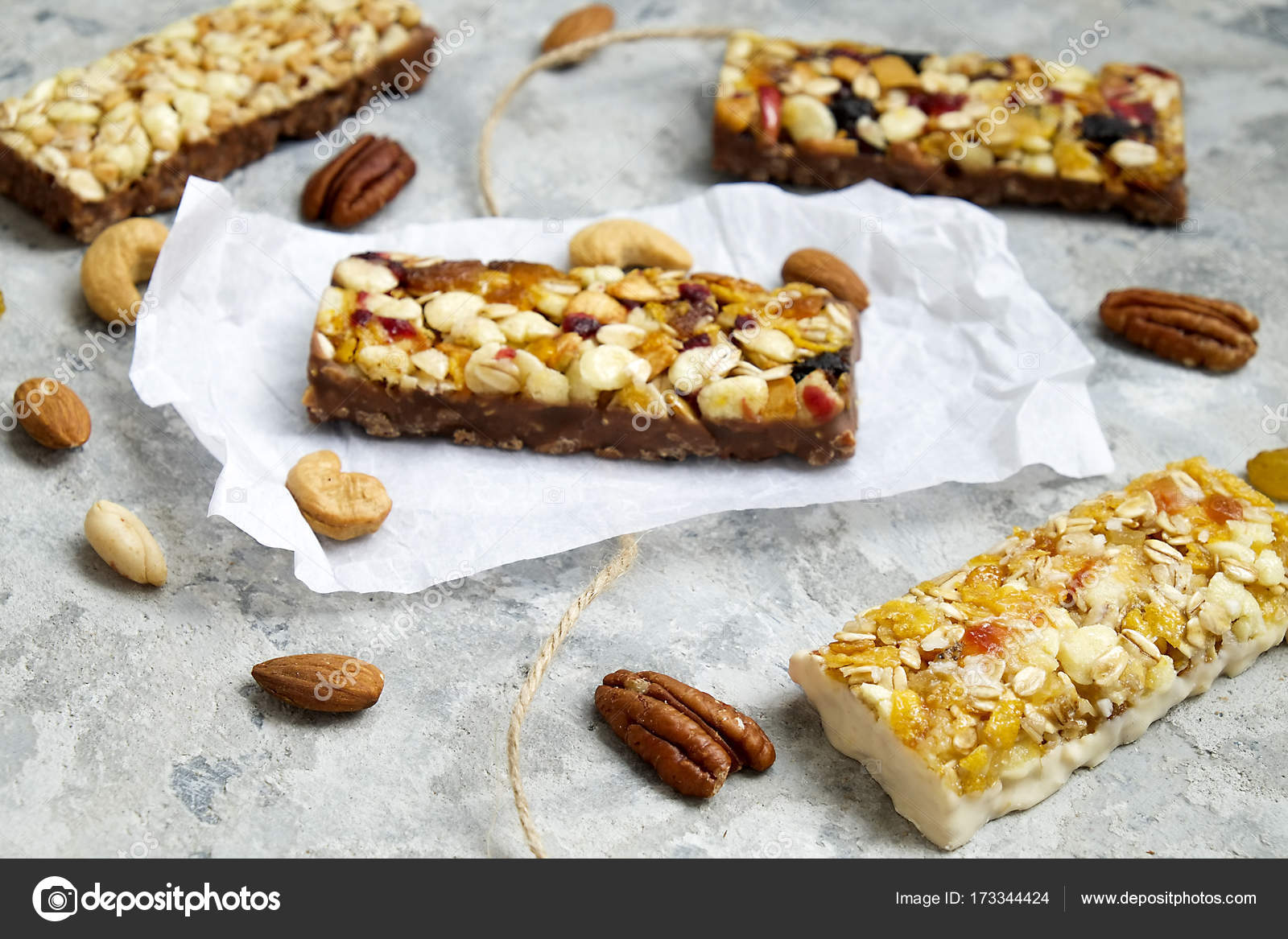 Healthy granola bars with nuts, seeds and dried fruits on the gray
