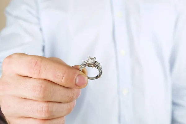Сцена помолвки / свадьбы / свадебного предложения. Крупный план человека, передающего дорогое золотое платиновое кольцо своей невесте . — стоковое фото