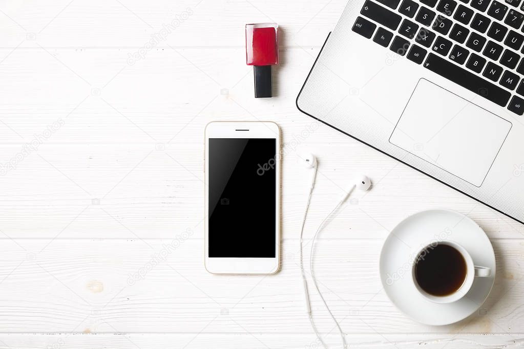 Blogger / businessman / businesswoman, it specialist's white wood office space table with laptop, blank screen smartphone, coffee cup and supplies. Top view, copy space, flat lay, overhead, backdrop.