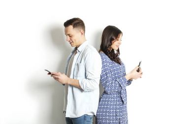 Genç bir mesaj okuma denetimi cep telefonu, çift. Teknoloji ve ilişki kavramı. Modern romantizm sorunları. Erkek ve erkek online uygulama dokunmatik ekran dating, sohbet, swiping, tarama, sörf.