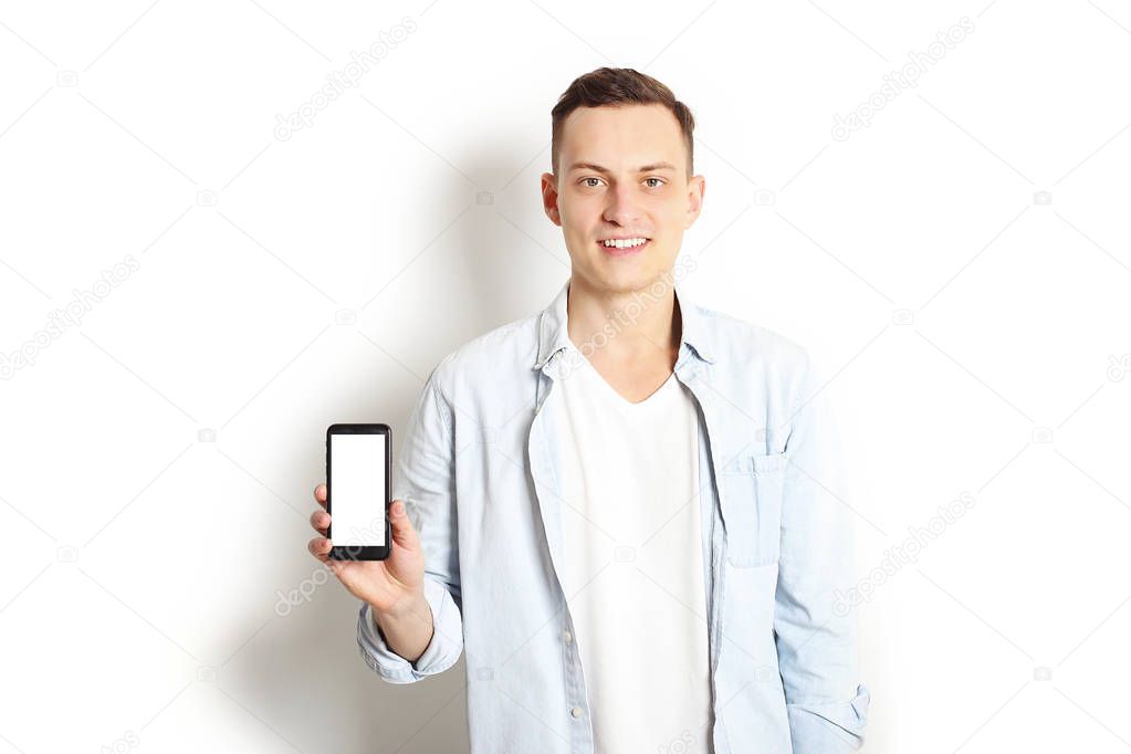 Male businessman displaying mobile phone happy smile looking at camera, isolated touch screen on white background