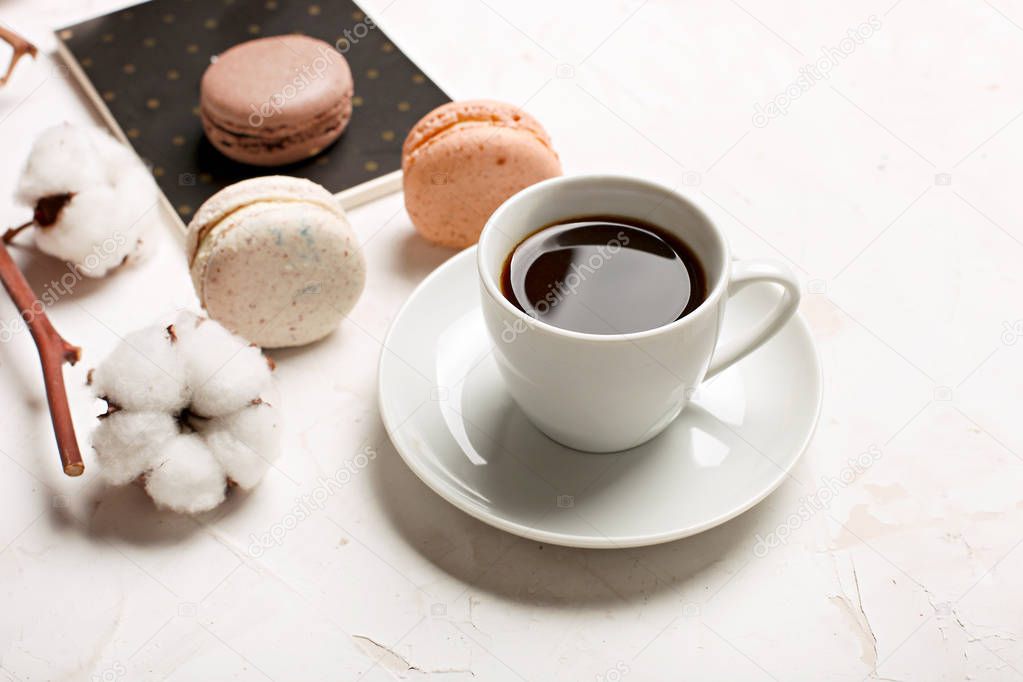 Traditional French almond caramel chocolate cranberry macarons dessert biscuits platter on white gray concrete textured background table top. Tasty but unhealthy food.