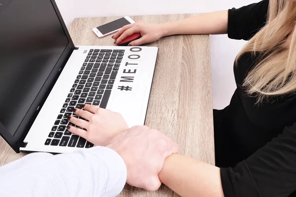 Boss man shows inappropriate behavior towards young woman at workplace desk. Violent male grabs grope female co worker. Office space, laptop computer. Sexism, mt m2 concept. Closeup background