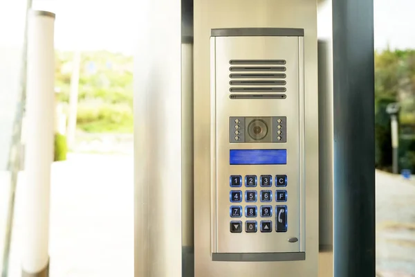 Modern electronic security technology on the front door entrance. Advanced intercom lock on new appartment complex.