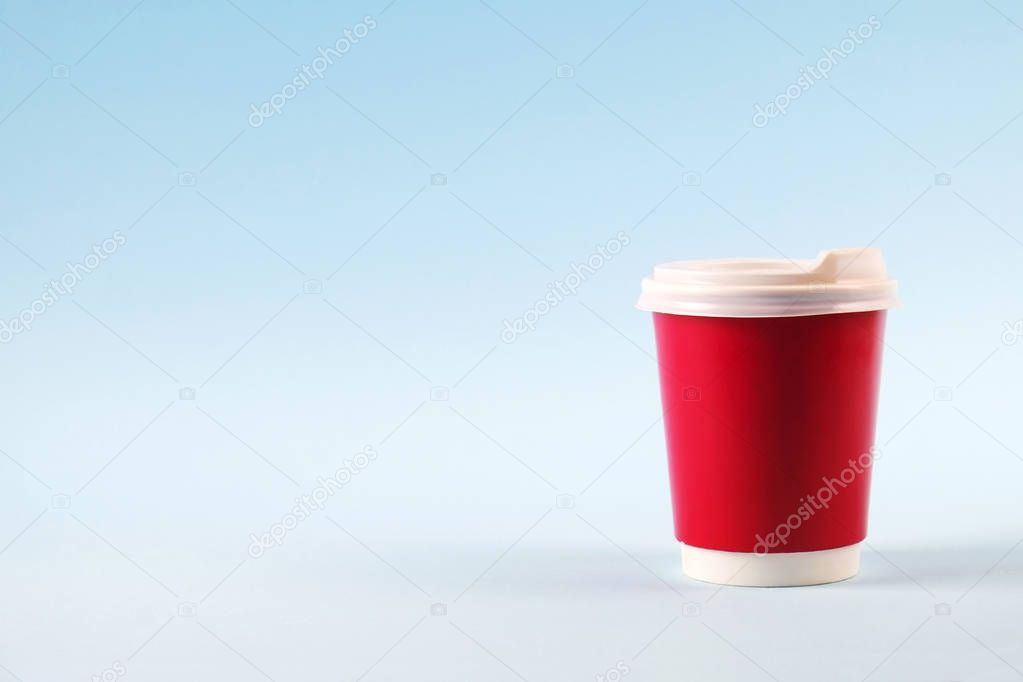 Colorful simplistic minimal composition with heat proof paper coffee cup. Take out tea mug with plastic cap. Coffee shop concept.