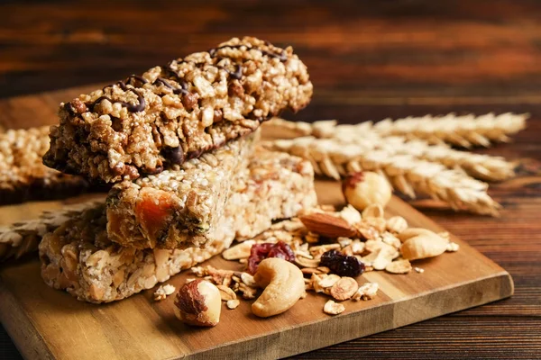 Close up of fitness food power bar with different kinds of mixed nuts. Vegetarian sweets with no harm for the figure. Background.