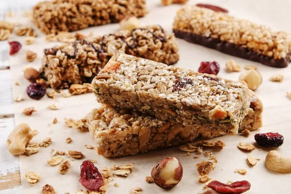 Close up of fitness food power bar with different kinds of mixed nuts. Vegetarian sweets with no harm for the figure. Background.