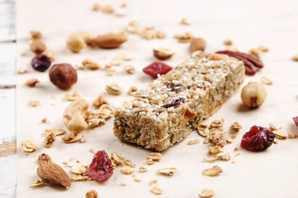 Close up of fitness food power bar with different kinds of mixed nuts. Vegetarian sweets with no harm for the figure. Background.