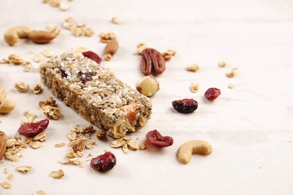 Close up of fitness food power bar with different kinds of mixed nuts. Vegetarian sweets with no harm for the figure. Background. — Stock Photo, Image
