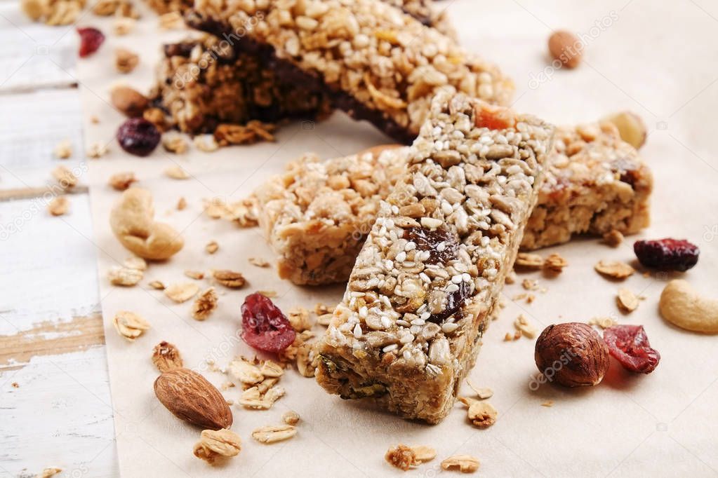 Close up of fitness food power bar with different kinds of mixed nuts. Vegetarian sweets with no harm for the figure. Background.