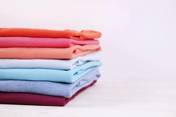Komposition mit gefalteter Kleidung, Unisex für Mann und Frau, verschiedene Farbe und Material. Stapel Wäsche, chemisch saubere Kleidung — Stockfoto