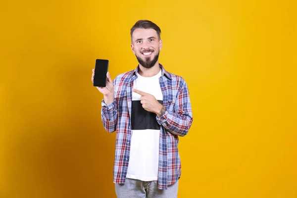 Homem barbudo perfeitamente preparado com penteado elegante posando sobre fundo amarelo . — Fotografia de Stock