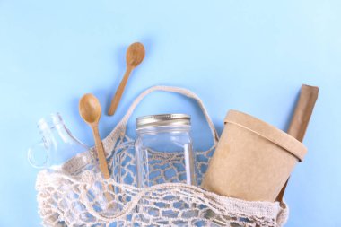 Paket servisi ve market alışverişi için çevre dostu yeniden kullanılabilir öğelere sahip yassı kompozisyon ve kağıt dokulu arka plan üzerine metin için bir sürü fotokopi alanı. Kapat, üst görünüm.