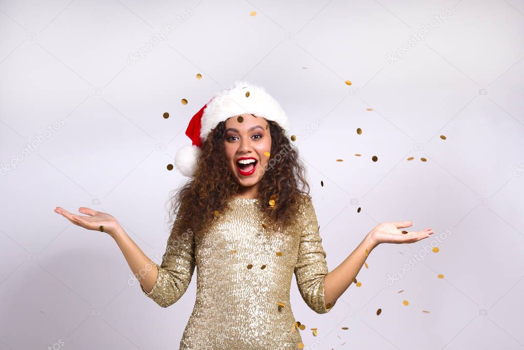 Beautiful young woman being happy, celebrating winter holidays.