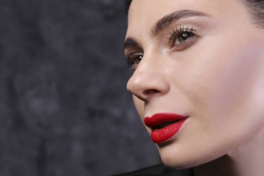 Makyajını gösteren esmer saçlı kadın portresi..
