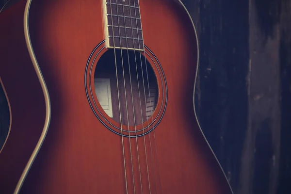 Six string folk acoustic guitiar over aged wood background. — 图库照片