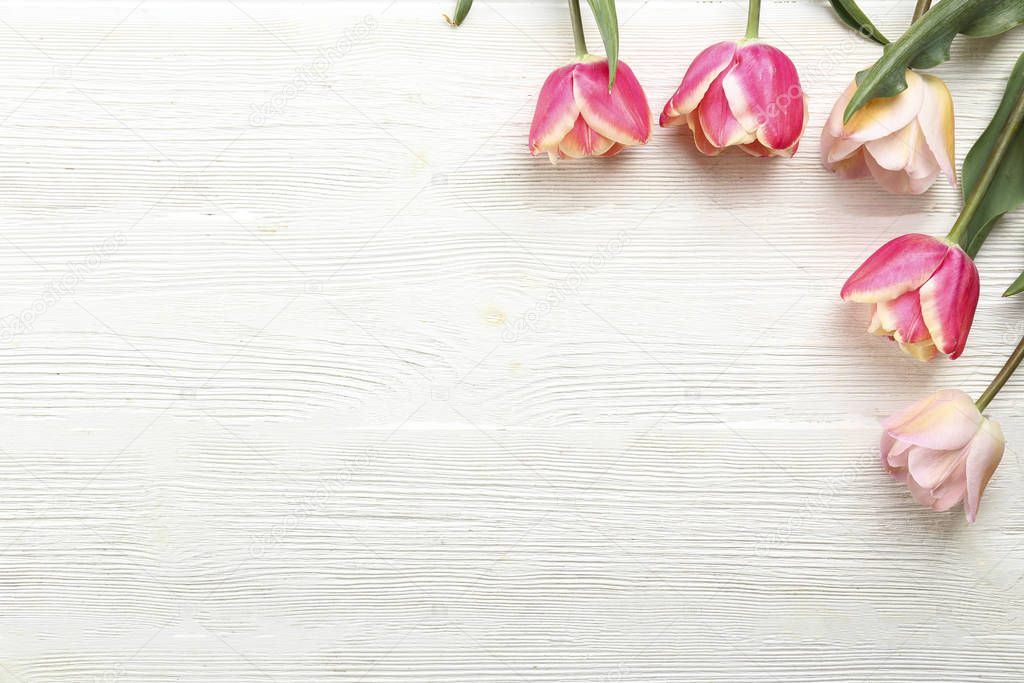 Bunch of spring flowers on textured table backgound with a lot of copy space for text. Top view, close up, flat lay composition.