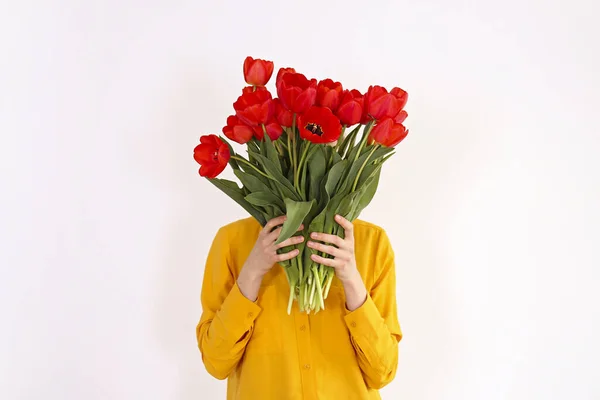Conceptual image of a woman holding spring flowers as present fo — ストック写真