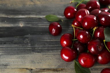 Sweet cherry scattered on textured background with text space.