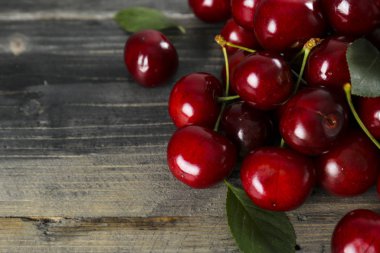 Sweet cherry scattered on textured background with text space.