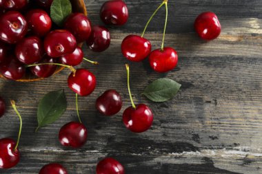 Sweet cherry scattered on textured background with text space.