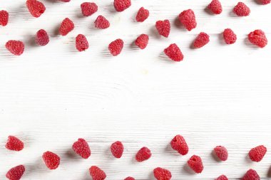 Sweet raspberry scattered on textured background with text space.