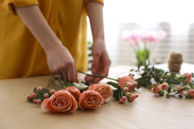 Cropped shot of a woman arranging bouquet of flowers.