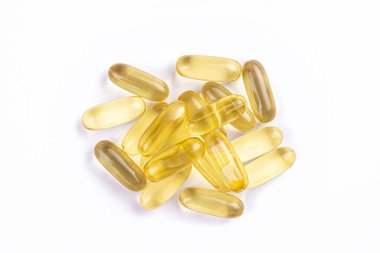 Omega 3 balık karaciğer yağı kapsülleri yığın desen arka plan oluşturan grup. Büyük altın yarı saydam hapları dokusuna yakın çekim. Sağlıklı her gün beslenme ek. Üstten görünüm, düz yatıyordu, kopya alanı.