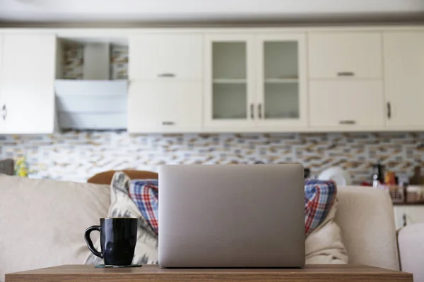 Unrecognizable man chilling on couch with hands behind head, watching shows online. Staying home during quarantine self isolation period. Living room interior, kitchen background. Copy space, close up