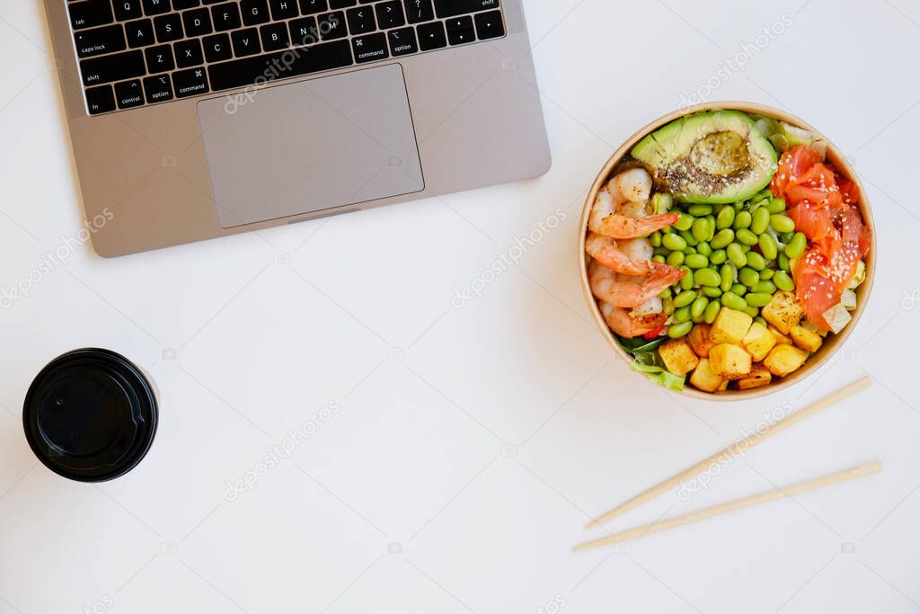 Clean eating diet concept. Vegeterian seafood bowl with smoked salmon, shrimp avocado and green beans in take out paper container. Close up, copy space, top view, background.