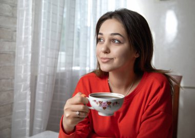 Mutfaktaki masada dijital kitap okuyan bir kız.