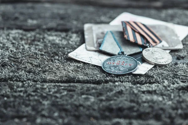 The Old Soviet Medal - For Bravery of the Second World War on natural moss background, Victory Day May 9