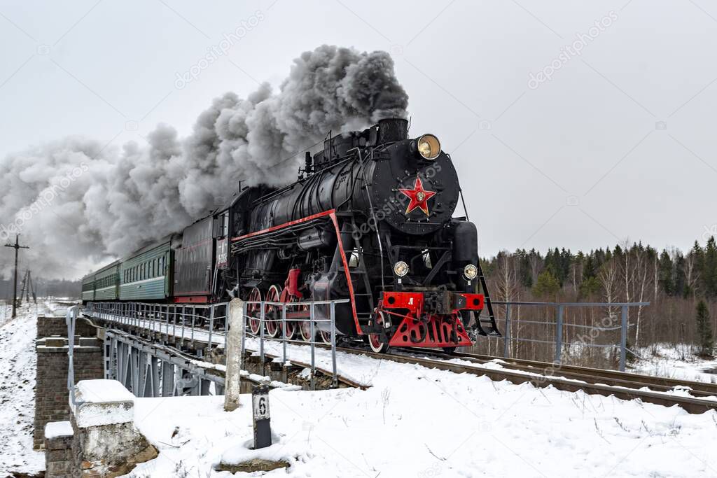 Steam train in the winter on the flight Bologoe-Ostashkov, Tver region, Russia.